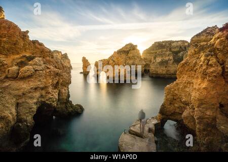 Robuste felsigen Küste, Felsen und Bögen in Ponta da Piedade bei Sonnenaufgang, Lagos, Algarve, Portugal Stockfoto