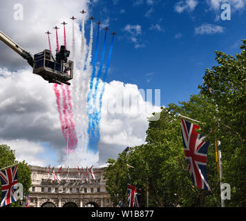 Rote Pfeile flypast über Admiralty Arch in die Mall mit Union Jack Fahnen und TV-Kamera Kran für Trooping Geburtstag des Farbe Queen London England Stockfoto