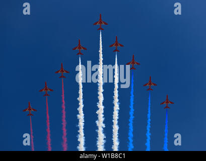 Bildung von RAF Red Arrows mit farbigen Spuren auf blauen Himmel für Flypast auf die Farbe für Queen Elizabeth's 93. Geburtstag London England Stockfoto