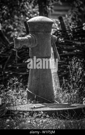 Alte handbetriebene Wasserpumpe in einer Seitenstraße Stockfoto