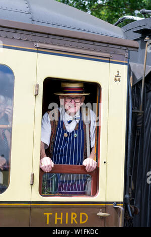 Kidderminster, Großbritannien. 29 Juni, 2019. Severn Valley's Eisenbahn Tep zurück in die 40er Jahre" einen fabelhaften Start dieses Wochenende mit kostümierten Re-enactors ihren Part spielen, eine authentische Rekonstruktion der Kriegszeit Großbritannien. Ein älterer Herr gekleidet wie ein Vintage Metzger im Stroh Bootsfahrer und Schürze aus dem Fenster sieht. Quelle: Lee Hudson Stockfoto