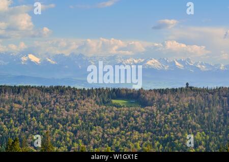 Charmante Feder Berglandschaft. Schneebedeckte Gipfel über die wunderschönen Hügel. Stockfoto