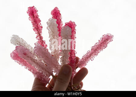 Hand mit cristalized Lollipop mit lebendigen Farben Stockfoto