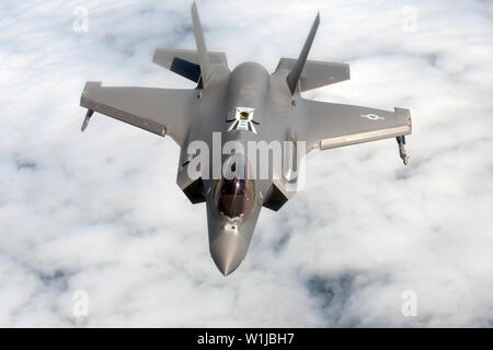 Ein US Air Force F-35A Lightning II, an die 388 Fighter Wing zugeordnet, fällt unter einen US Air Force KC-135 Stratotanker, RAF Mildenhall, England, während der Übung Point Blank zugeordnet über der Nordsee, 27. Juni 2019. Training mit gemeinsamen Partnern, alliierten Nationen und anderen Einheiten der US Air Force trägt zu unserem bereit und posierten Kräfte und versetzt uns in die Lage, nachhaltige und strategische Beziehungen notwendig, eine breite Palette von globalen Herausforderungen zu begegnen. (U.S. Air Force Foto von älteren Flieger Benjamin Cooper) Stockfoto