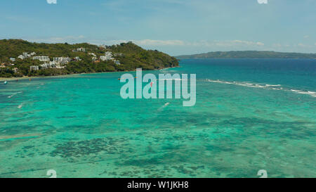 Tropischen Strand mit türkisblauen Wasser mit Kite-surfer reitet, Luftbild. Kitesurfen auf einer tropischen Insel. Boracay, Philippinen Stockfoto