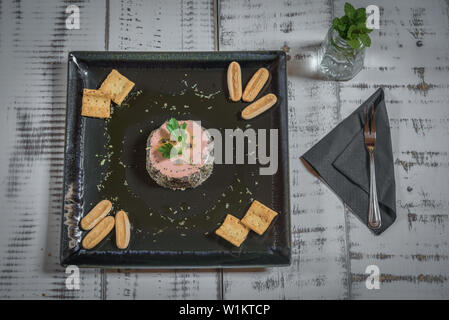 Ente Pastete mit Pfeffer serviert auf einem schwarze Platte mit Brot Croutons Stockfoto