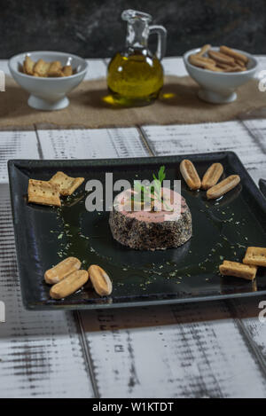 Ente Pastete mit Pfeffer serviert auf einem schwarze Platte mit Brot Croutons Stockfoto