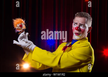 Zirkus Clown führt. Ein Mann in einem Clown Outfit mit einem Spielzeug Stockfoto