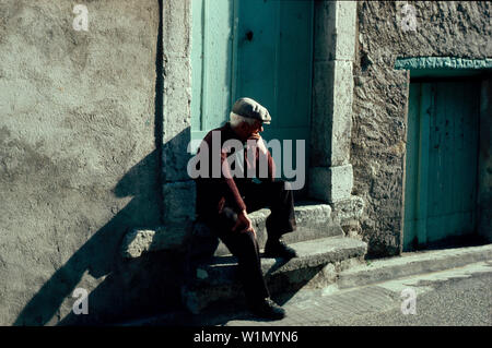 Alte Mann sitzt auf der Treppe in der Provence, Frankreich Stockfoto