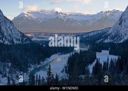 Ein Fluss fließt durch eine winterliche Bergwelt Banff. Es ist der Blick aus dem Fairmont Banff Springs Hotel in das Bow River Tal. Banff, Alber Stockfoto