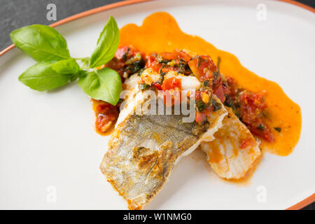 Zwei koteletts von line-gefangen Pollack Pollachius pollachius, im Englischen Kanal gefangen, die pan-wurden angebraten und mit gebratener chili Flocke serviert. Stockfoto