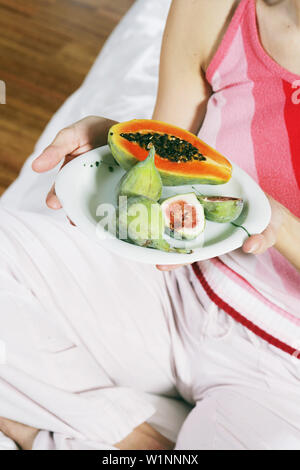 Nahaufnahme einer jungen Frau mit einer Platte von exotischen Früchten, Essen Stockfoto
