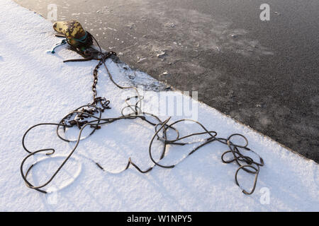 Stahldrahtseil Kabel und rostige Kette im Schnee Stockfoto