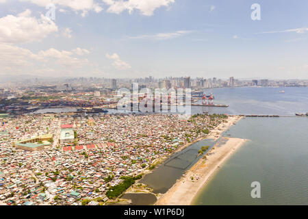 Port in Manila, Philippinen. Sea Port mit Cargo Cranes. Stadtbild mit armen Gebieten und Business Center in der Entfernung, Ansicht von oben. Asiatische Metropole. Stockfoto