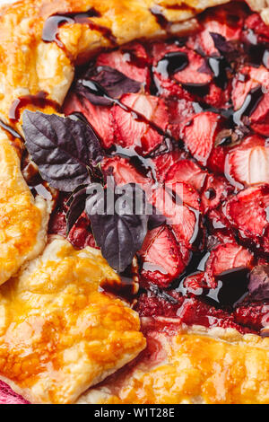 Hausgemachte Erdbeere öffnen pie Gallet mit lila Basilikum und Balsamico Dressing auf einem hellen Hintergrund. Close Up. Stockfoto