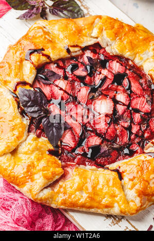 Hausgemachte Erdbeere öffnen pie Gallet mit lila Basilikum und Balsamico Dressing auf einem hellen Hintergrund. Close Up. Stockfoto