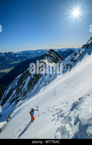 Frau backcountry Skiing aufsteigend zu Fuß auf die Steilwand, Hochmiesing, Spitzing, Bayerische Alpen, Oberbayern, Bayern, Deutschland Stockfoto