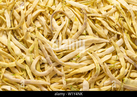 Hintergrund der organischen Flach gelb Wachs Bohnen, verschiedene Größen und Formen. Stockfoto