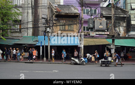 Bangkok, Thailand - 2018.03.23; Personen, die vor der alten Geschäftshäuser in Bangkok Chinatown Stockfoto