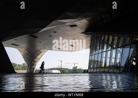 04 Juli 2019, Frankreich (Frankreich), Lyon: Besucher gehen unter dem Museum 'Musée des Confluences". Foto: Sebastian Gollnow/dpa Stockfoto