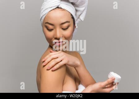 Schöne asiatische Frau Schönheit Porträts. Chinesisches Mädchen stand vor dem Spiegel und kümmert sich um Ihr Aussehen. Beauty Studio Aufnahmen Stockfoto