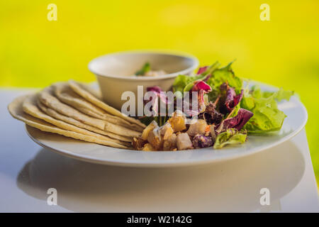 Hummus mit tortillas auf einem weißen Tisch Stockfoto