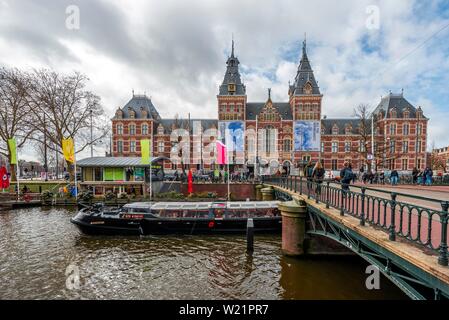 Ausflugsschiff und Brücke über Spiegelgracht mit Rijksmuseum, dem Reichsmuseum Amsterdam, Noord-Holland, Niederlande Stockfoto