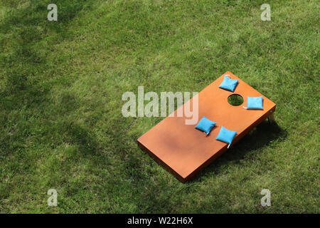 Ansicht von oben werfen Taschen in ein Loch cornhole Bohne Beutelwurf Rasen Spiel Stockfoto