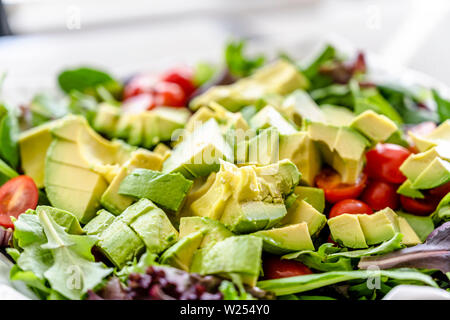 Für Liebhaber von einem gesunden Lebensstil und für diejenigen, die Gewicht verlieren und sich fit halten, eine organische, Salat, Tomaten und Avocado, gewürzt mit Olivenöl Stockfoto