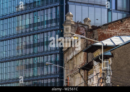 Bukarest, Rumänien - Juli 07, 2019: Ein modernes Hochhausgebäude, genannt die Markierung Turm, im Gegensatz zu einigen alten Gebäuden auf einer Straße in Bucha Stockfoto