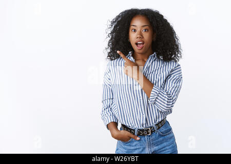 Studio shot begeistert gefühlvolle afrikanische amerikanische Frau Nacherzählung super Lage, die zurück linke obere Ecke offenen Mund unterhalten Reden stun aufgeregt Stockfoto