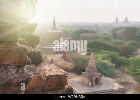 Blick über die Pagoden von Bagan, antike Tempel Komplex während der Sunrise golden hour in Myanmar. Mauer im Vordergrund. Stockfoto