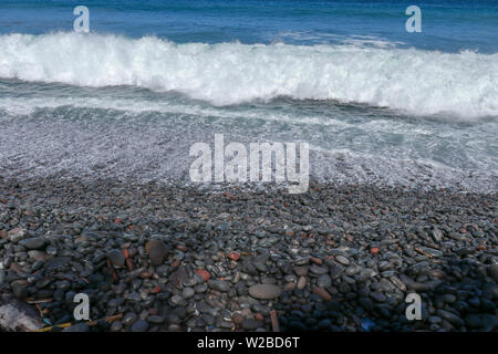 Stony Ozean Küste durch die Meeresbrandung ausgewaschen. Wellen auf die Felsen an der Küste brechen. Wellen drehen in ein Meer aus Schaumstoff, die zurück ins Meer fließt. Stockfoto