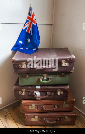 Australien, Victoria, VIC, Bonegilla Bonegilla, die Migrantinnen erleben Museum, post-WW2 immigrant Werk, Gehäuse Kaserne Innenraum, Gepäck und Australische Flagge Stockfoto