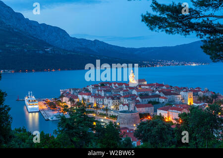 Erhöhten Blick auf Korculas malerischen Stari Grad leuchtet bei Dämmerung, Korcula, Dalmatien, Kroatien Stockfoto