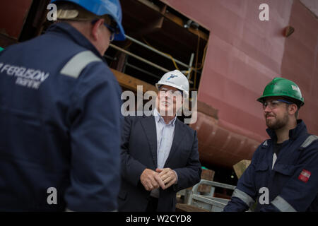 Jim McColl (tragen weiße hardhat) von Clyde Gebläse Kapital, Gespräche mit der Werftarbeiter, in Ferguson Marine Werft am Fluss Clyde fotografiert, in Port Glasgow, Schottland, am 12. Juni 2019. Stockfoto