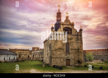 Fassade der Alten Kirche in alten Burgruinen unter bunten bewölkter Himmel Stockfoto