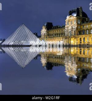 Beleuchtete Louvre Glaspyramide mit Spiegelbild im Wasser, Dämmerung, Paris, Frankreich Stockfoto