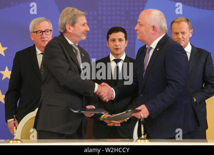 Kiew, Ukraine. 8. Juli, 2019. Präsident der Ukraine Volodymyr Zelenskiy (C), der Präsident des Europäischen Rates Donald Tusk (R) und des Präsidenten der Europäischen Kommission, Jean-Claude Juncker (L) stehen hinter der Europäische Kommissar für Europäische Nachbarschaftspolitik und Erweiterung Verhandlungen Johannes Hahn und vice-PM Stepan Kubiv Unterzeichnung einer Vereinbarung während des Gipfels in Kiew, Ukraine, 8. Juli 2019. Das 21. Gipfeltreffen EU-Ukraine findet in Kiew mit Besuch des Präsidenten des Europäischen Rates und der Europäischen Kommission. Credit: sergii Kharchenko/ZUMA Draht/Alamy leben Nachrichten Stockfoto