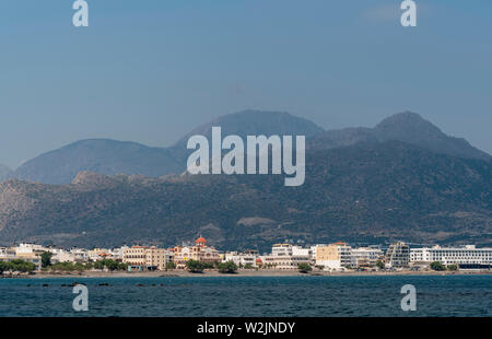 Kreta, Griechenland. Juni 2019. Im südlichen Kreta und die Stadt Ierapetra mit der Kirche von Agia Fotini und die Berge in der Nähe der Waterfront Stockfoto