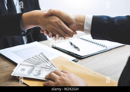 Unehrlich in der Geschäftswelt zu betrügen illegal Geld, Geschäftsmann handshake Geld von Dollarnoten in den Händen von während der Erfolg der Deal, Bestechung und corru Stockfoto