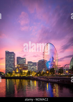 Eine Aussicht auf eine brillante Sonnenuntergang über der Yokohama Skyline bei minato-mirai und der Cosmo Wecker 21 Riesenrad, wie vom VN-Park gesehen. Yokohama, Japan. Stockfoto