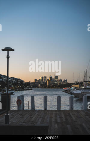 Pyrmont, New South Wales - 28. JUNI 2019: mit Blick auf die North Sydney Skyline von Pyrmont Bay Park. Kurz nach Sonnenuntergang in der Dämmerung Geschossen. Stockfoto