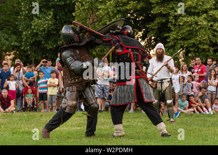 Nis, Serbien - Juni 15. 2019 Zwei Ritter Kampf auf dem Schlachtfeld. Wiederaufbau der Ritter Schlachten auf dem Festival mit der Öffentlichkeit. Nahaufnahme Stockfoto