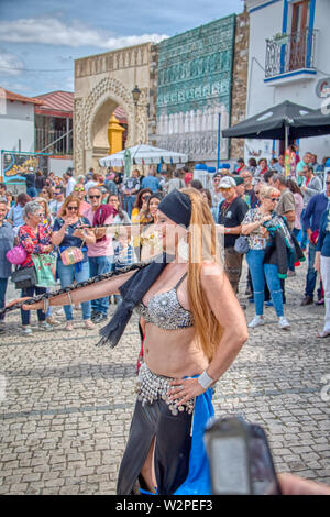 Mertola, Portugal - 18. Mai 2019: hübsche Frau tanzen auf der Straße arabischen Tanz an das Islamische Festival in Mertola, einem wunderschönen portugiesischen Villag gehalten Stockfoto