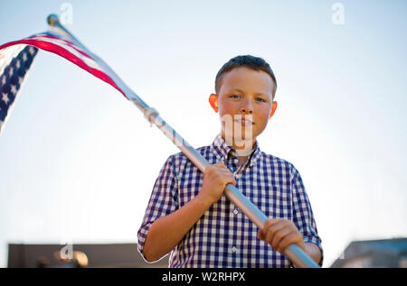 Porträt eines Jungen Holding eine amerikanische Flagge. Stockfoto