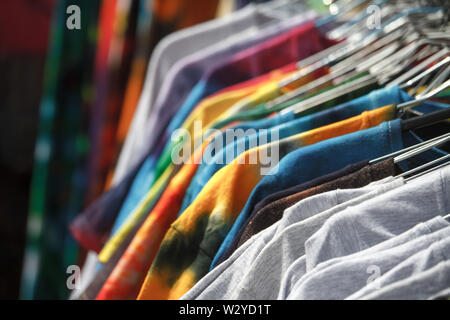 Nahaufnahme des bunten T-Shirts auf Bügeln hängend in der Straße, fair, Secondhand, Recycling Konzept Stockfoto