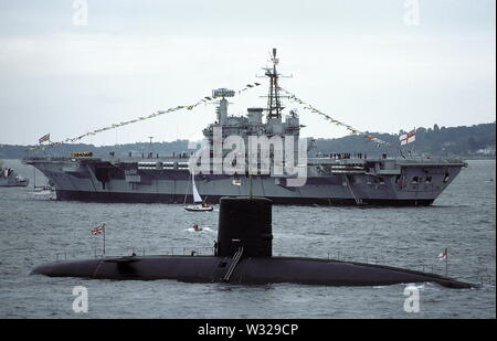 AJAXNETPHOTO. 1977. SPITHEAD, ENGLAND - ATOMKRAFT - HMS CHURCHILL, 4.900 Tonnen, im Jahre 1970, war einer der ersten, alle nuklearen ABGESCHLOSSEN angetriebenen U-Booten IN DER BRITISCHEN ROYAL NAVY. Zu sehen HIER AUF DER SILVER JUBILEE FLOTTE überprüfen; IM HINTERGRUND IST DER FLUGZEUGTRÄGER HMS HERMES. Foto: JONATHAN EASTLANDAJAX. REF: CD 21207 1 91. Stockfoto