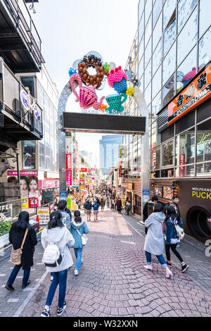 Tokio, Japan - April 2, 2019: Berühmte Takeshita Straße Straße in Harajuku mit Masse von Menschen zu Fuß durch Restaurant shops stores Gebäude von Eingang A Stockfoto