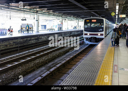 Tokio, Japan - April 4, 2019: Bahnhof Plattform lokale Linie nach Nikko mit viele Leute stehen auf der Plattform und JR Zeichen Stockfoto